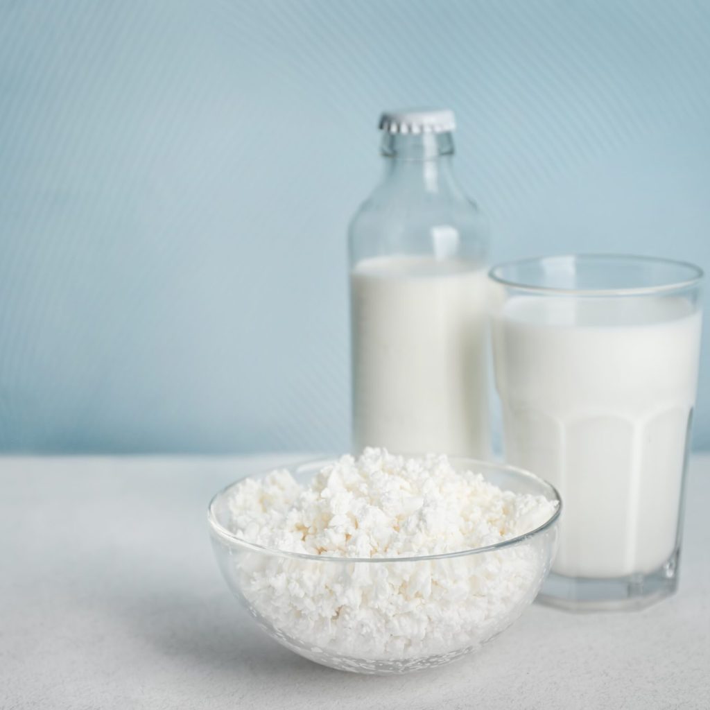Milk and cottage cheese on table. Fresh dairy products